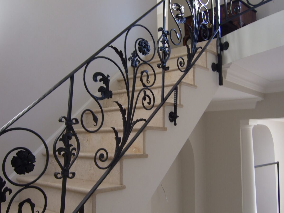 Stone Tables & Staircases — Cream limestone staircase treads with wrought-iron balustrade — Pontyclun