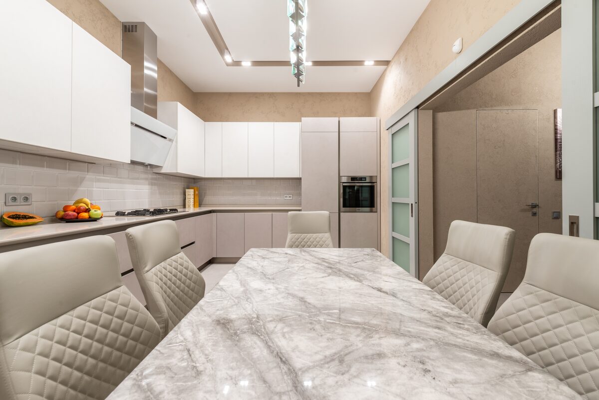 Stone Tables & Staircases — Bookmatched marble dining table with kitchen worktop run — Swansea